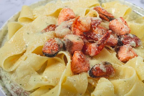 Papardelle pasta in creamy sauce with seafood, homemade, no people