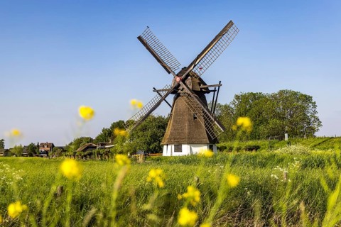 Landscape with typical Dutch windmill, classic windmill under monumental protection. Werkendam,