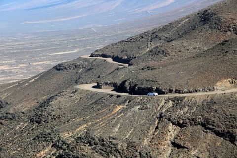 Car driving on unsurfaced road, Atlantic Ocean coast, Jandia peninsula, Fuerteventura, Canary
