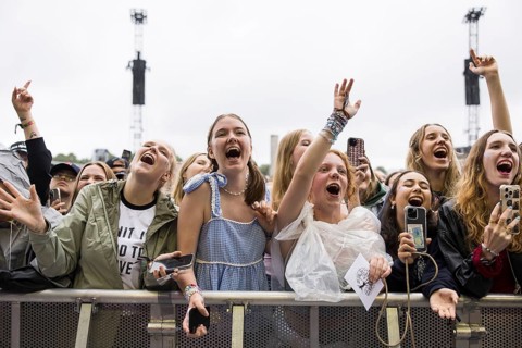 Festival visitors celebrate Mark Ambor's performance at the Lollapalooza Festival in the