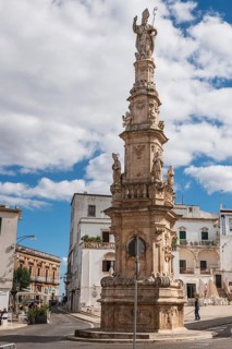 OSTUNI, ITALY - SEPTEMBER 26, 2018: Statue of St Oronzo on a column in the central square (Piazza