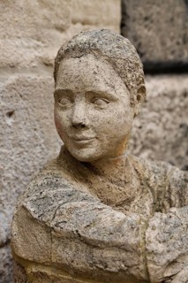Sculpture in front of the old school building, art in public space, stone figure, sculpture by the