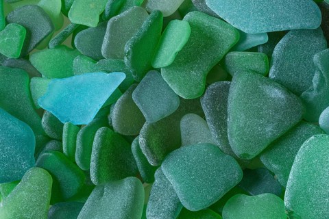 Green broken glass cut by the sea, sea glass, sea glass, beach glass from the North Sea