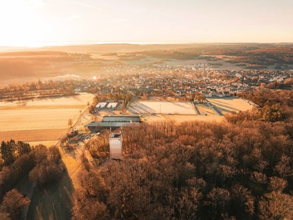 Panoramic view of a town and neighbouring fields in the warm light of the morning, Gechingen,