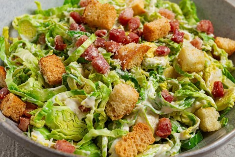 Brussels sprouts Caesar salad, with bacon and croutons, healthy food, homemade, no people