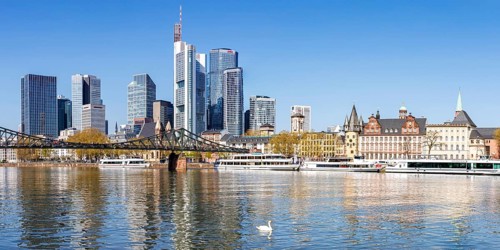 Frankfurt skyline skyscrapers with banks on the river Main with excursion boats and Eiserner Steg