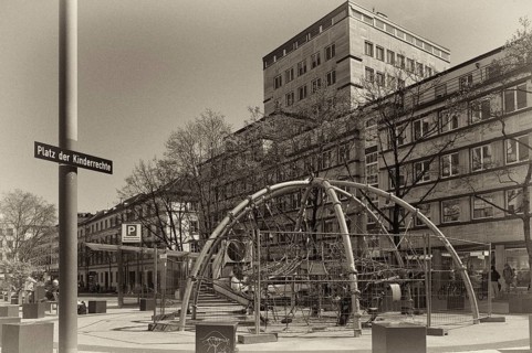 Street sign, CHILDREN'S RIGHTS SQUARE, children's rights square next to it, play equipment,