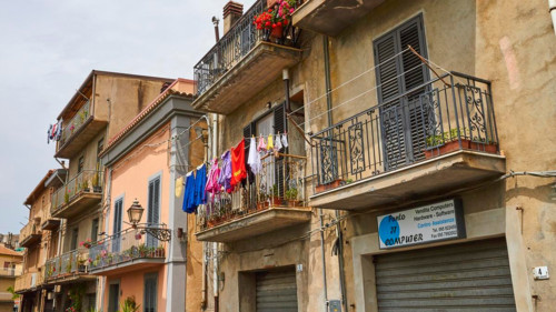 Row of houses, balconies, laundry on line, Randazzo, town, Nebrodi National Park, Sicily, Italy