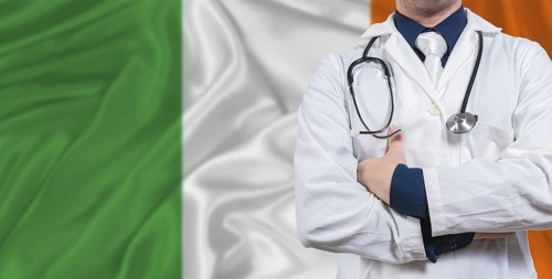 Male doctor with stethoscope on Irish flag. Doctor holding stethoscope on Irish flag