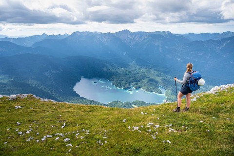 Hiker in the mountains, view of Eibsee lake and Werdenfelser Land, Wetterstein Mountains,