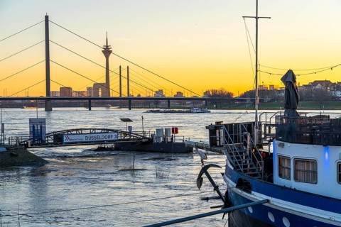 Sunset on the Rhine near Düsseldorf, skyline of the city centre with Rhine Tower, Rheinkniebrücke,
