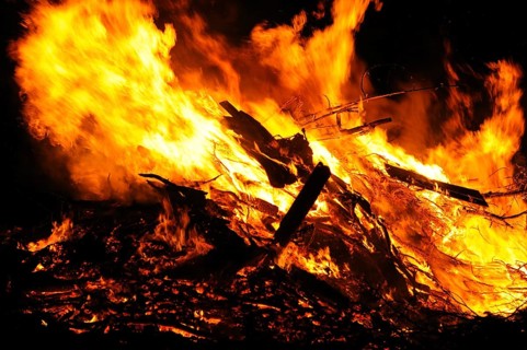 An intense fire with large flames consumes wood and produces a fierce ember, campfire, Easter fire,