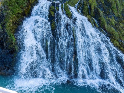Waterfall at the Bay of Last Hope, fjords and mountains, Puerto Natales, Patagonia, Chile