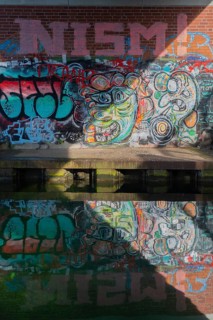 Grafitti under the city railway bridge at Linderner harbour, lock, canal, reflection, Limmer,