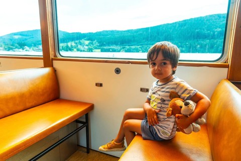 A boy on holiday inside the boat on Lake Titisee in the Black Forest, Germany