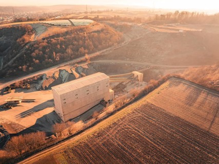 View over an industrial building and quarry in a rural, hilly area, Magstadt, Germany