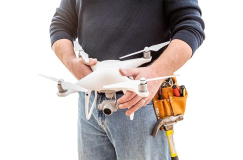 Construction Worker and Drone Pilot With Toolbelt Holding Quadcopter Drone Isolated on White