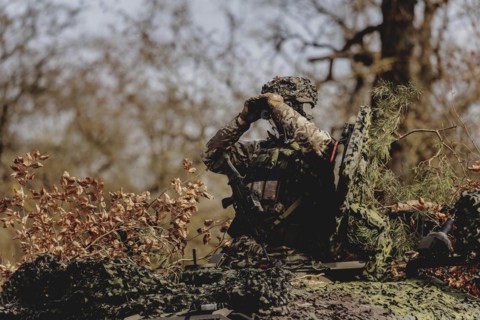 A Czech soldier drives through a forest as part of the military exercise 'Wettiner Schwert' with
