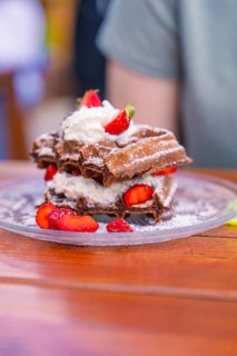 Delicious chocolate waffles served with cream and fresh strawberries, Cafehäusle Calw, Black