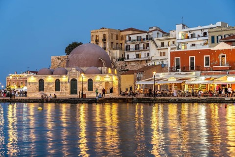 Restaurants and the Hasan Pasha Mosque at the old Venetian harbour at dusk, Chania, Crete, Greece