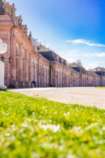 Elegant historic palace with a view of a green meadow and blue sky in the sunshine, Schwetzingen
