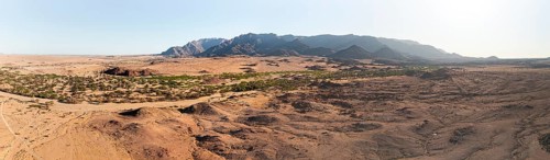 Aerial view, dry riverbed and desert landscape on the Ugab River, behind Brandberg, Erongo,