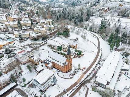 Snow-covered village from the air, centrally located a church in the winter snow, St.Bonifatius,