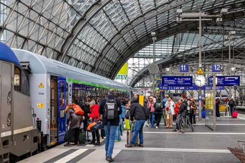 EuroCity to Warsaw at Berlin Central Station. Travelers on the platform. Berlin, Germany
