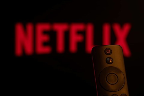Dhaka, Bangladesh- 21 Jan 2026: Close-up of a smart TV remote control against a blurred Netflix