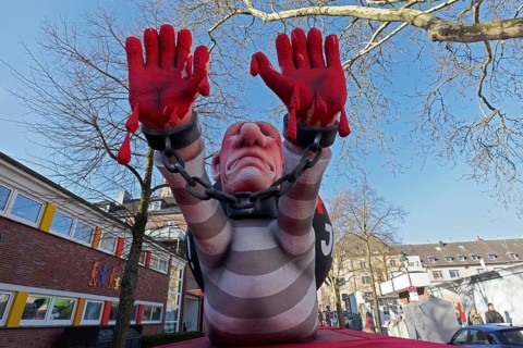 President Putin as a convict with blood on his hands, Put In Jail, papier-mâché figure, theme float