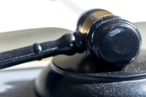Symbolic picture court hearing: close-up of a judge's hammer and the civil code