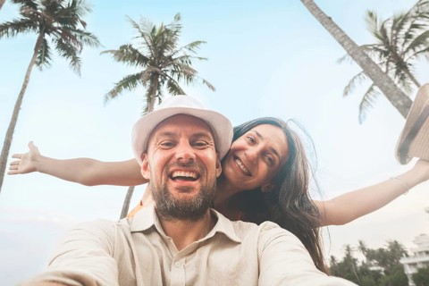 Young happy couple visit coconut island pose happy face taking holiday photo selfie in Sri lanka,