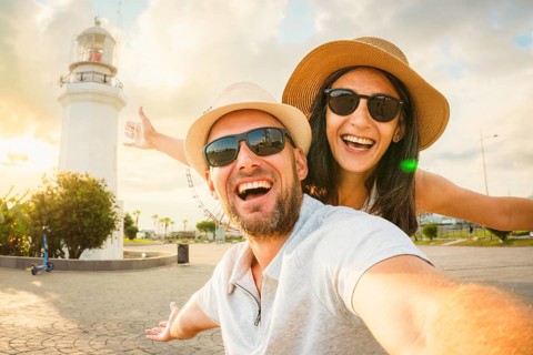 Young excited caucasian couple in love smiling taking selfie pov at Batumi Boulevard with iconic
