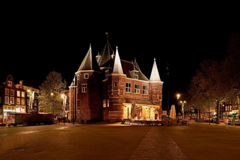 Medieval building De Waag illuminated at night, at Nieuwmarkt, Amsterdam, North Holland,