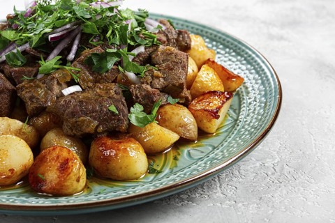 Kuyrdak, roast offal with potatoes and fresh herbs, homemade in Kazakh, no people