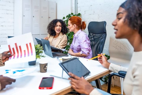 Young diverse and multiracial people working in coworking space analyzing data