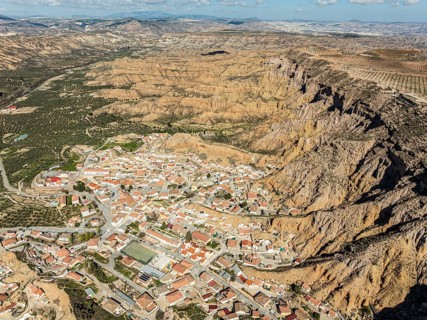 Village Gorafe at the foot of a deep gorge, aerial view, Gorafe Desert, UNESCO Granada Geopark,