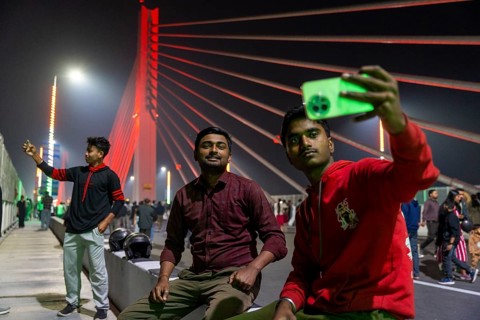 Young men take selfies on the newly inaugurated Kumar Bhaskar Varma Setu, a six-lane cable-stayed