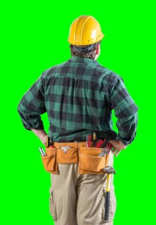 Rear view of construction worker wearing tool belt and holding hard hat on green screen