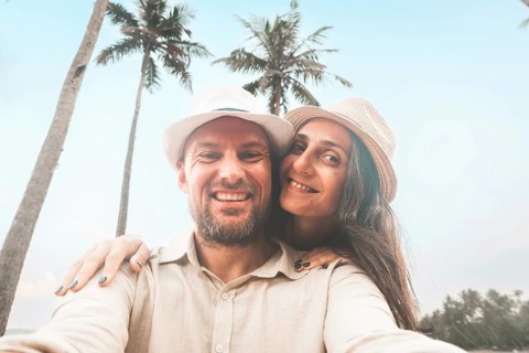 Young happy couple visit coconut island pose happy face taking holiday photo selfie in Sri lanka,