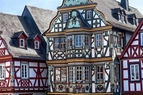 Killingerhaus, magnificent half-timbered house, colourful painted carvings on the bay window,