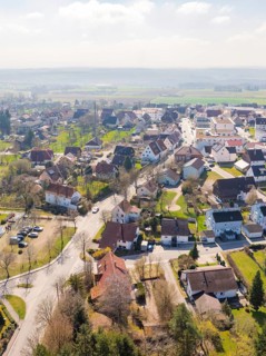 Spacious settlement with red roofs and surrounded by green landscape on a sunny day, Nagold