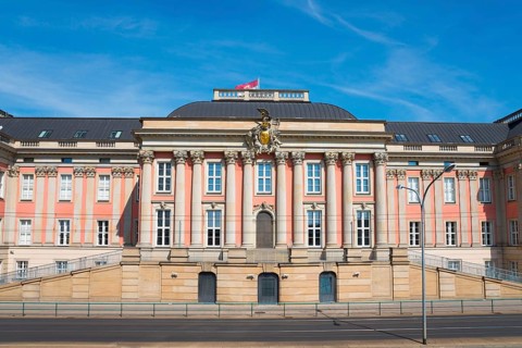 Historic building with baroque façade and columns under a blue sky, City Palace and State