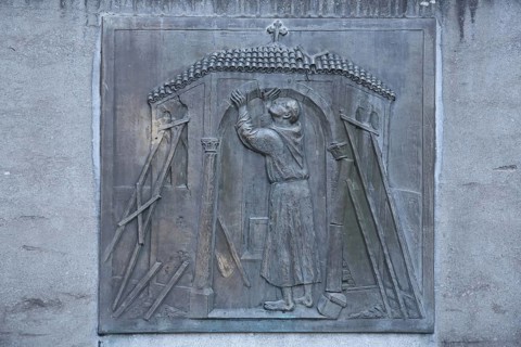 Relief of Saint Francis with symbol of the historic structure of the church, church institution,