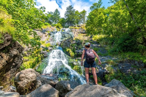 A female tourist in summer at the Todtnau waterfall in the Black Forest in Germany