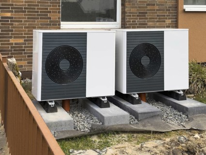 2 heat pumps are installed on an apartment block in a front garden, Hilden, Germany