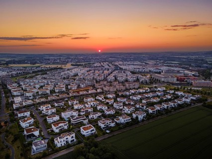 The sun rises behind the Riedberg district of Frankfurt. (Aerial photo with a drone), Riedberg,