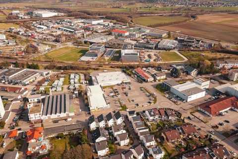 A view of an urban landscape with a central supermarket and industrial facilities, Gärtringen,