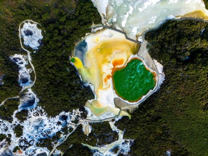 Aerial view of the vibrant Champagne Pool at Wai-O-Tapu geothermal park, New Zealand, showcasing