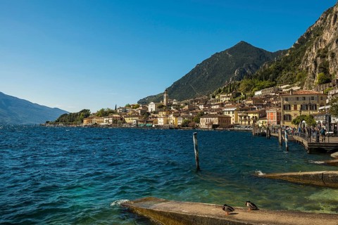 Picturesque village and colorful houses on the lake and steep mountains, Limone sul Garda, Lake